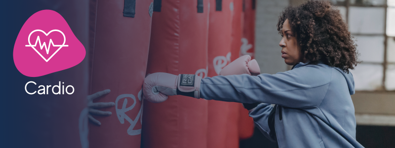 woman punching a punchbag with boxing gloves on with an icon indicating it is a box fit cardio class