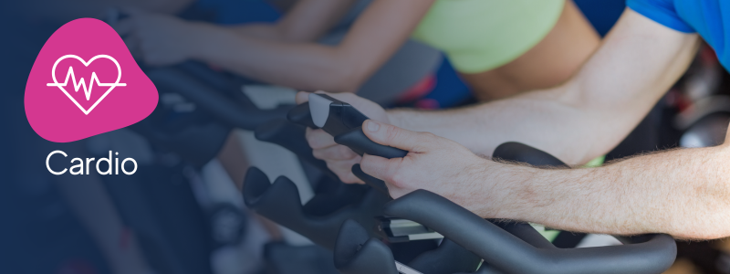 hands holding handlebars of indoor spinning bike with an icon indicating its a rhythm ride cardio workout