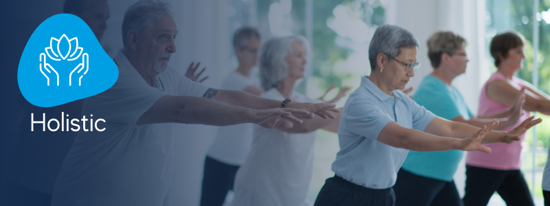 row of people performing moves in a tai chi class with an icon indicating its a tai chi holistic workout