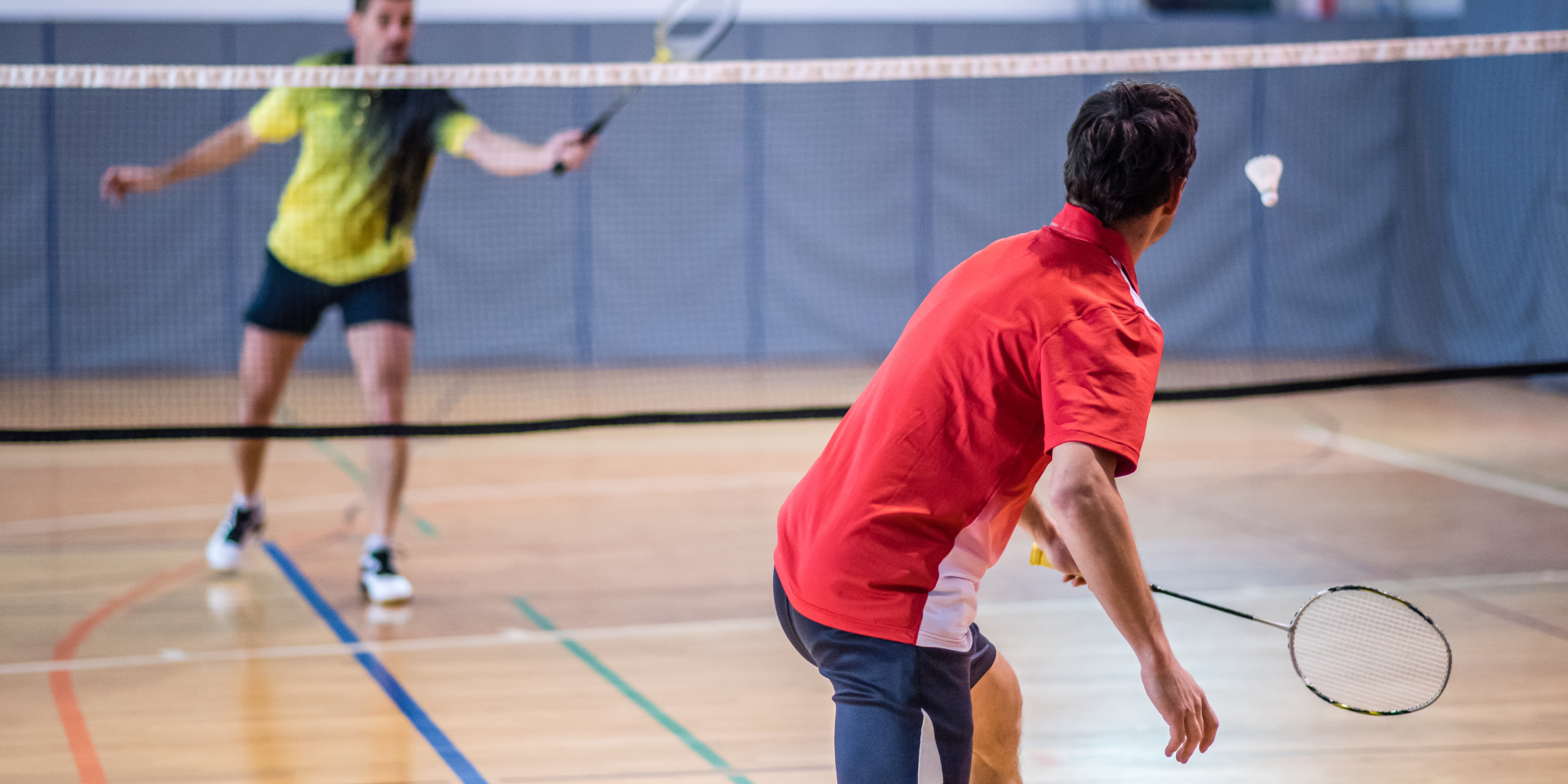 two people playing badminton