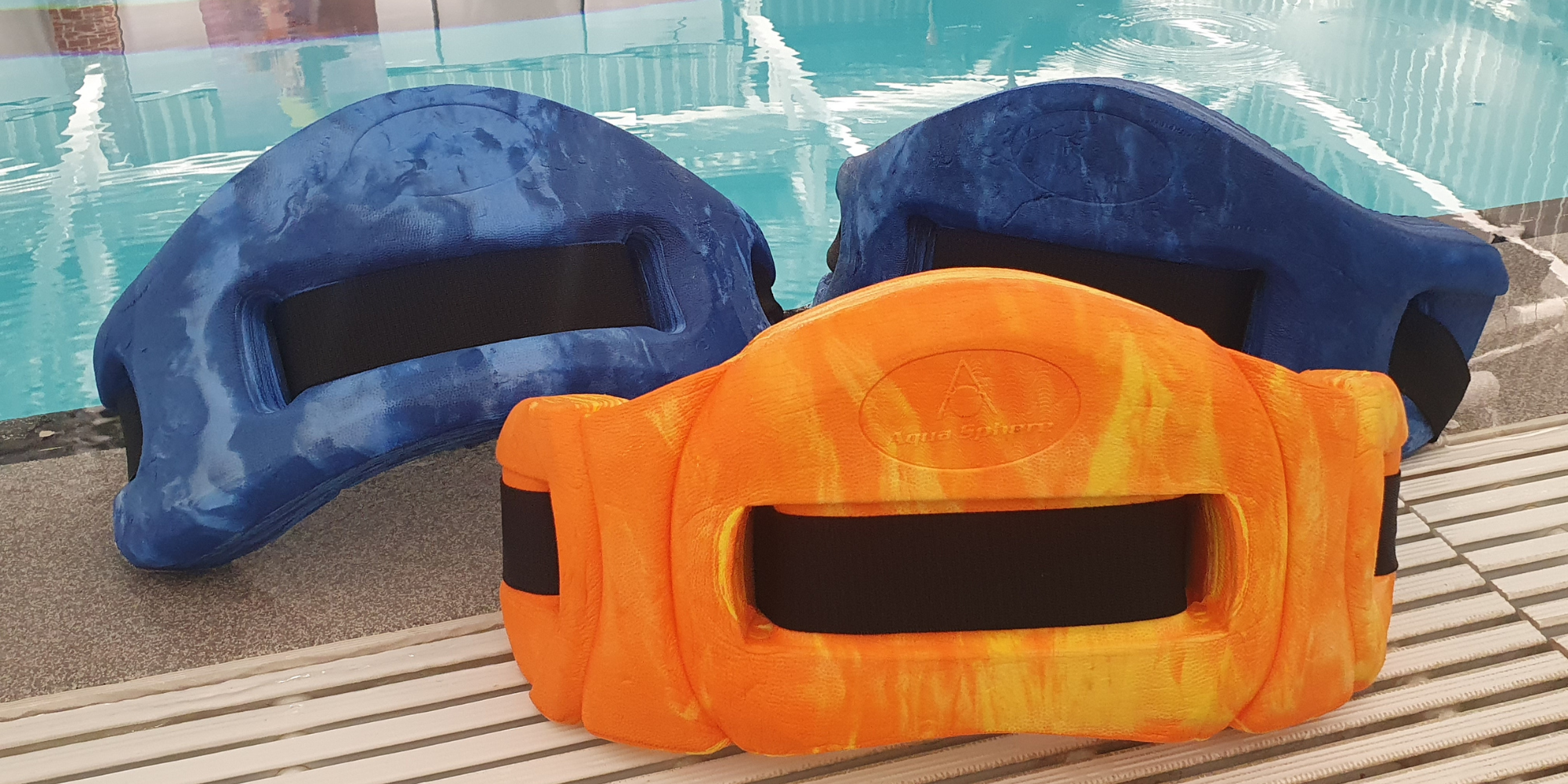 three flotation waist belts on poolside