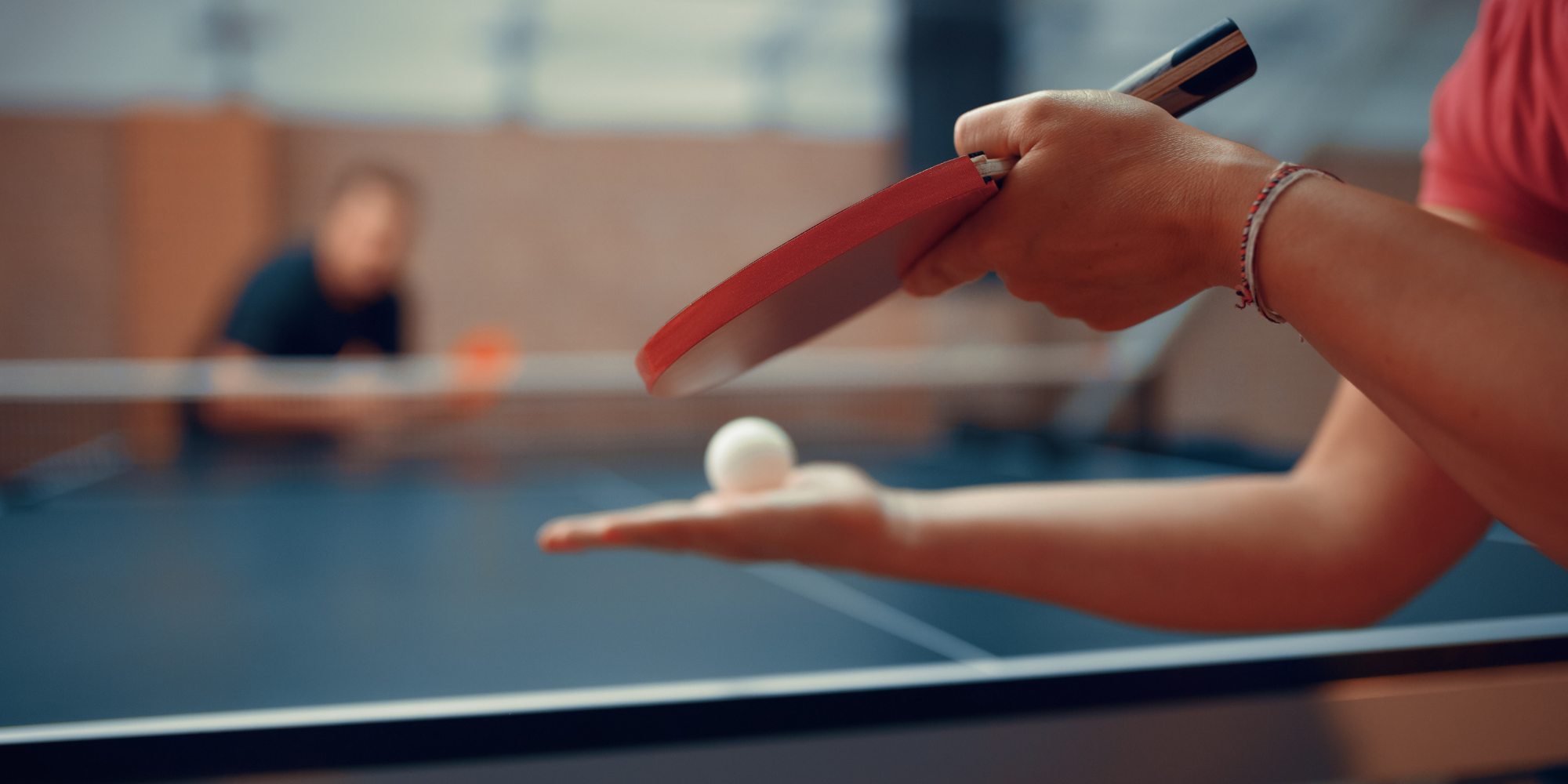 person serving during a game of table tennis