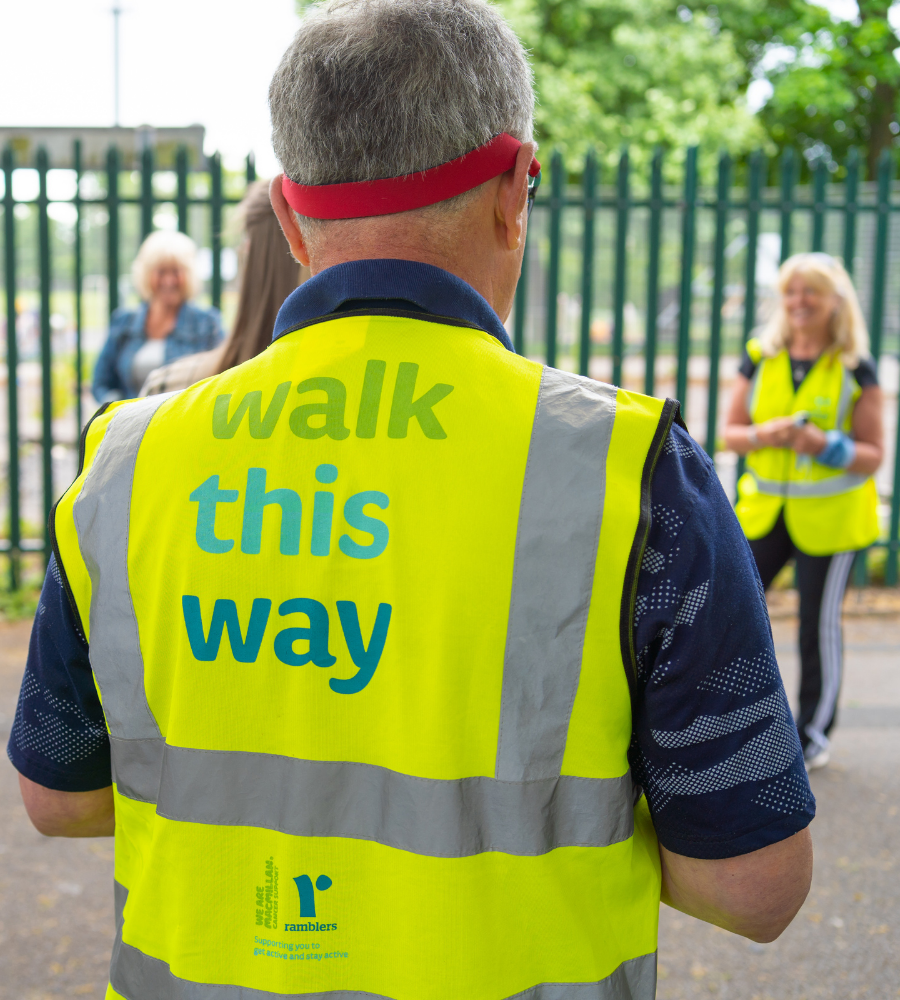 two well being walk leaders chatting to a group of walkers